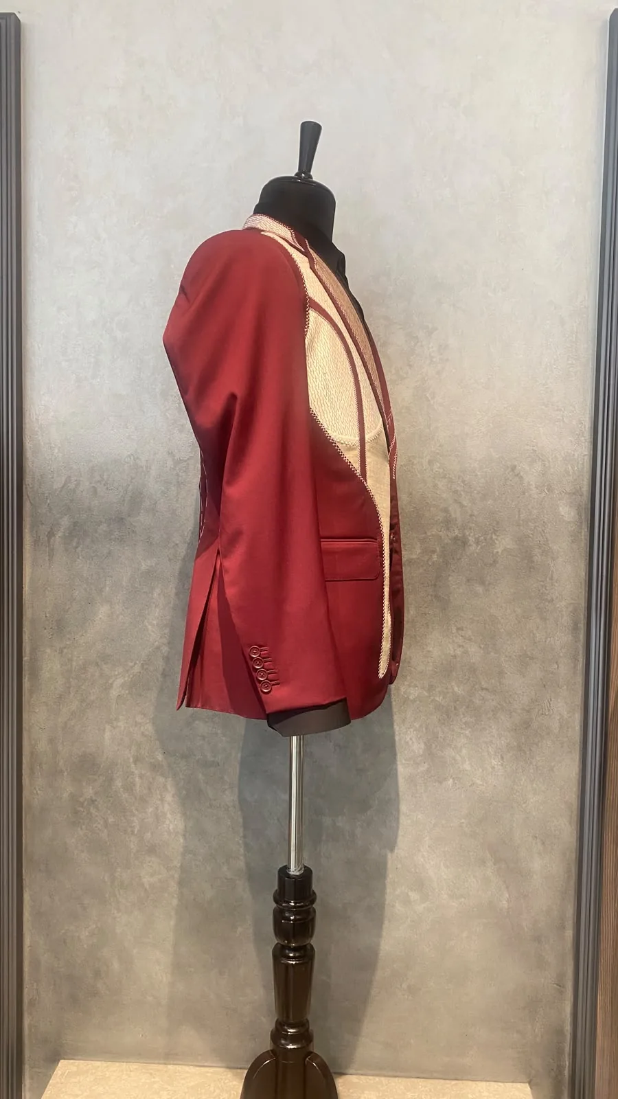 Side view of The Man Project burgundy jacket with contrasting cream handwork